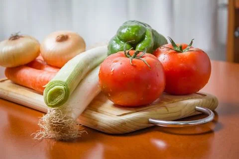 Fresh vegetables on cutting board in the kitchen Stock Photos