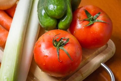 Fresh vegetables on cutting board in the kitchen Stock Photos