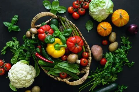Fresh vegetables on a dark kitchen surface Stock Photos