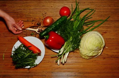 Fresh vegetables of different types on a dark background for salad grass raku Stock Photos