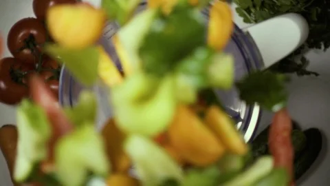 Fresh vegetables fall into the blender. Slow mo Video stock 74659692