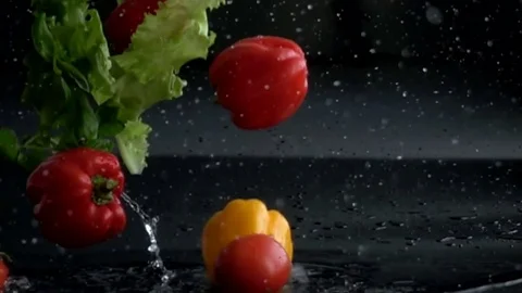 Fresh vegetables falling with water in slow motion Video stock 72359536