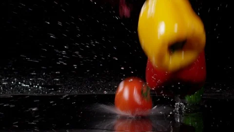 Fresh vegetables falling with water in slow motion on black background 動画素材 89340619
