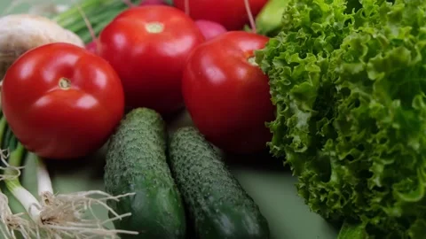 Fresh vegetables on a green background Stock Footage 220786908