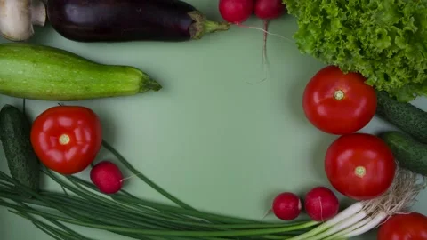 Fresh vegetables on a green background with a place to insert text, stop motion Stock Footage 220672761