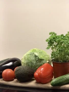 Fresh vegetables including avocado, cabbage, and bell pepper arranged Stock Photos