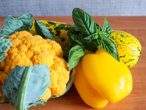 Fresh vegetables including yellow squash, cauliflower, and bell peppers on a Stock Photos