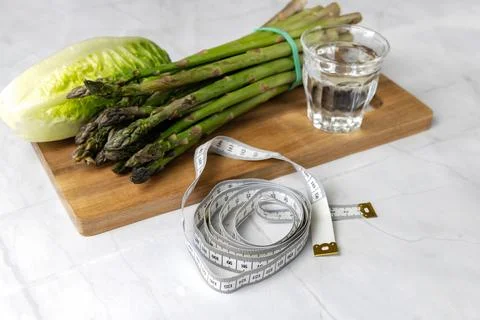 Fresh vegetables on the kitchen table cabbage, salad, asparagus. Stock Photos