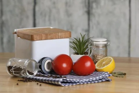 Fresh vegetables on the kitchen table. Tomato,jar of salt and pepper. Breakfast Stock Photos