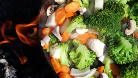 Fresh vegetables in a pan over a live fire Stock Footage 308643967