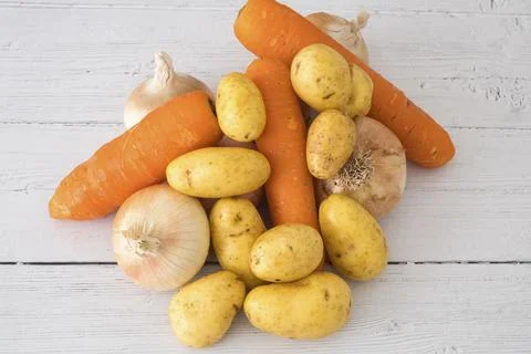 Fresh vegetables rest on rustic white wood Stock-Fotos