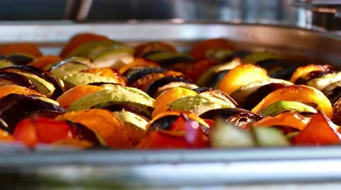 Fresh vegetables roasting in a clear dish in the oven Stock Footage 64886631