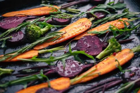 Fresh vegetables for roasting on rustic dark background Stock Photos