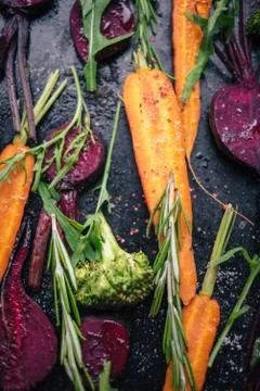 Fresh vegetables for roasting on rustic dark background Stock Photos