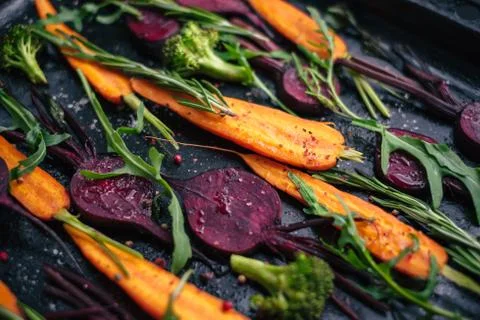 Fresh vegetables for roasting on rustic dark background Stock Photos
