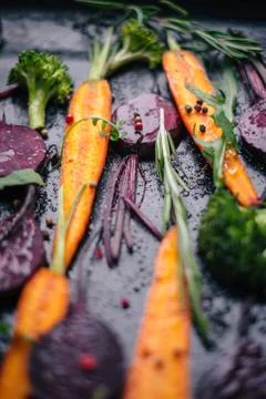 Fresh vegetables for roasting on rustic dark background Stock Photos