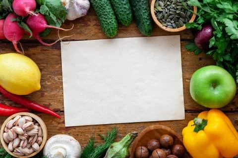 Fresh vegetables on rustic surface with space for your recipe on paper Stock Photos