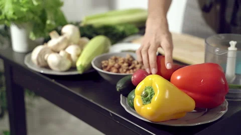 Fresh vegetables on the table. Hands picking pepper and tomatoes for salad Stock Footage 133324162