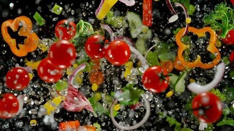 Fresh vegetables with water droplets exploding on black background. Stock Footage 121274744