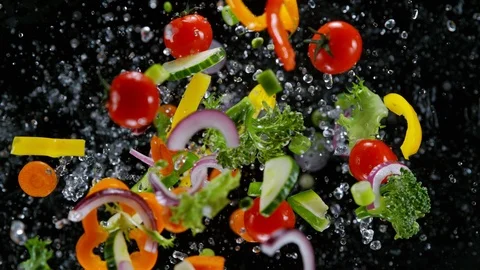 Fresh vegetables with water droplets exploding on black background. Stock Footage 123162117