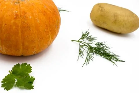 Fresh vegetables on a white background, flat lay: Potatoes, pumpkin, dill,    Stock Photos