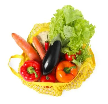 Fresh vegetables in yellow string bag isolated on white, top view Stock Photos