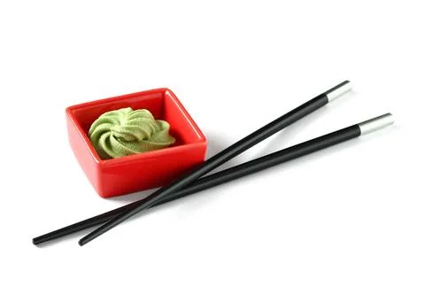 Fresh wasabi paste in red square bowl with black chopsticks for sushi and asi Stock Photos