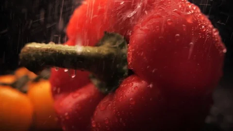 Fresh washed red bell pepper and yellow cherry on a black background. Close-up Stock-Footage 127458178