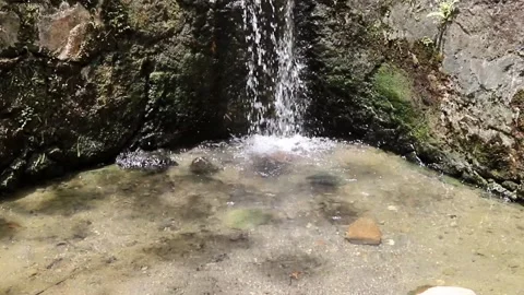 Fresh water falling in to a shallow pool Stock Footage 162707205