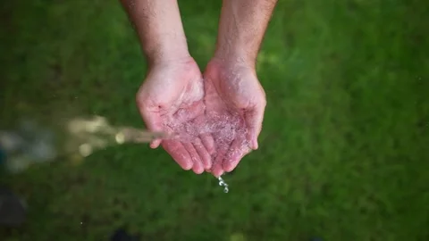 Fresh Water pouring down in person's hands Stock Footage 249918865