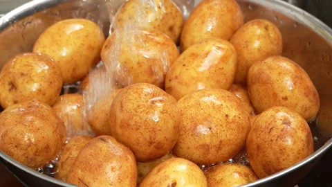 Fresh Water Pouring Over Raw Potatoes in Bowl Stock Footage 343602333