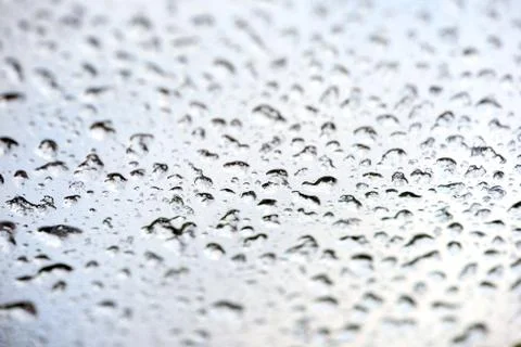 Fresh water rain drops and droplets on a clear glass window after a rainstorm Stock Photos