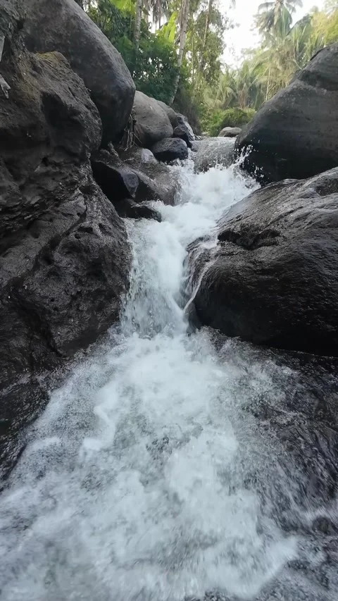 Fresh Waterfall Stream Cascading Over Natural Rocks in 4K Vertical Video Stock Footage 336748714