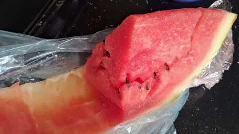 Fresh watermelon slice in plastic wrap showing motion video clip Stock Footage 339248179