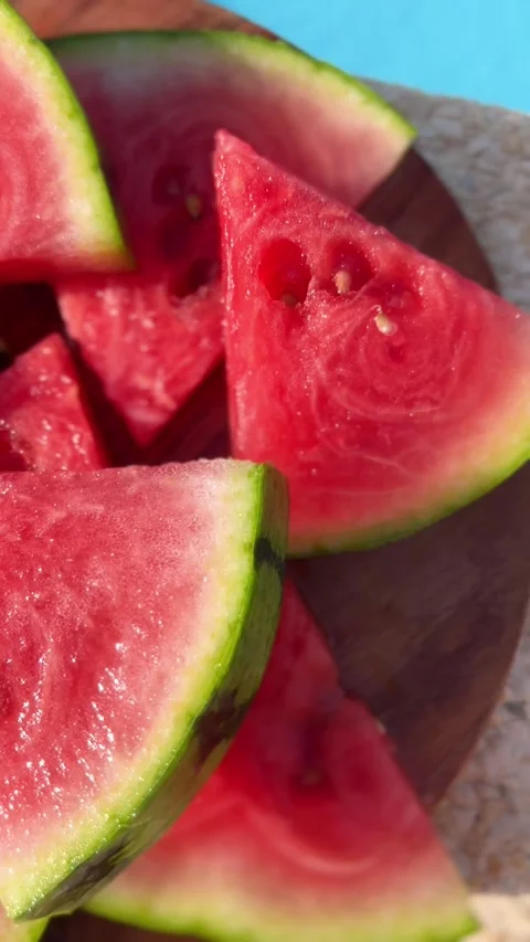 Fresh Watermelon Slices by the Poolside on a Sunny Summer Day Stock Footage 314362585