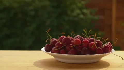 Fresh wet cherry on a plate Stock Footage 135864462