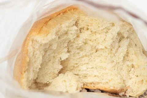 Fresh wheat bread in a clear plastic bag, broken inside the bag Stock Photos