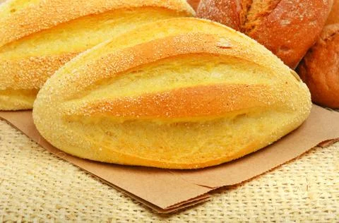 Fresh wheat buns on the sacking background. Stock Photos