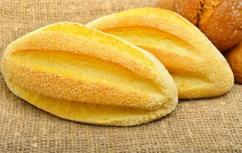 Fresh wheat buns on the sacking background. Stock Photos