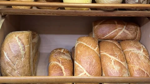 Fresh white bread loaves displayed on bakery shelves with soft texture and Stock Footage 345727761