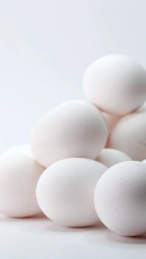 Fresh white chicken eggs in pyramid, smooth slider motion. Vertical Stock Footage 342937282