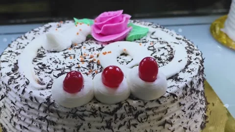Fresh White Cream Cake with Cherry Toppings Displayed in Bakery Showcase Vid Stock Footage 325334996