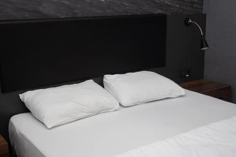 Fresh white Empty bed with pillows in bed room Stock Photos