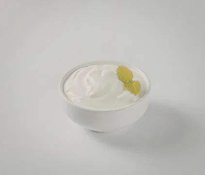 Fresh white yogurt with mint leaf garnish Stock Photos