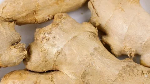 Fresh whole ginger root pieces circle rotation close up top view Stock Footage 274437742