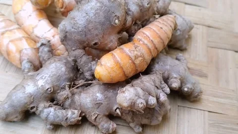 Fresh Whole Red Ginger and Turmeric Roots on a Natural Bamboo Mat Background Stock Footage 340538091