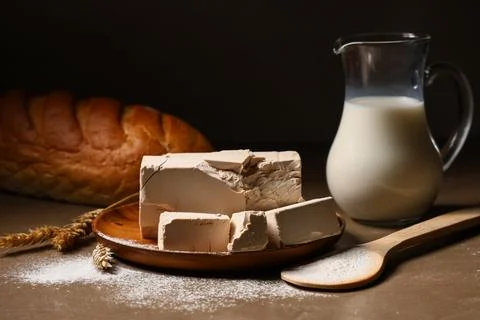 Fresh yeast blocks and baking ingredients for homemade bread production, milk Stock Photos