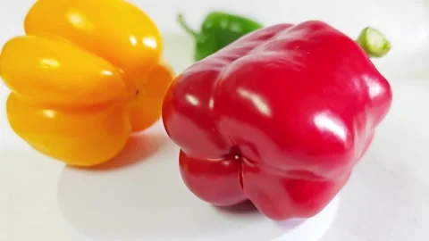 Fresh yellow and red bell peppers on a white background. Stock Footage 340938242
