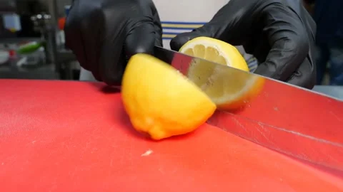 Fresh yellow citrus fruit slicing and extracting juice on a kitchen counter Stock Footage 345510375