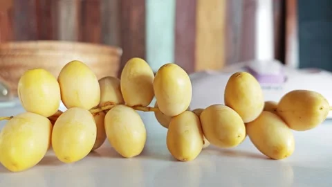 Fresh Yellow Dates Branch on White Table Closeup. Stock Footage 340486959